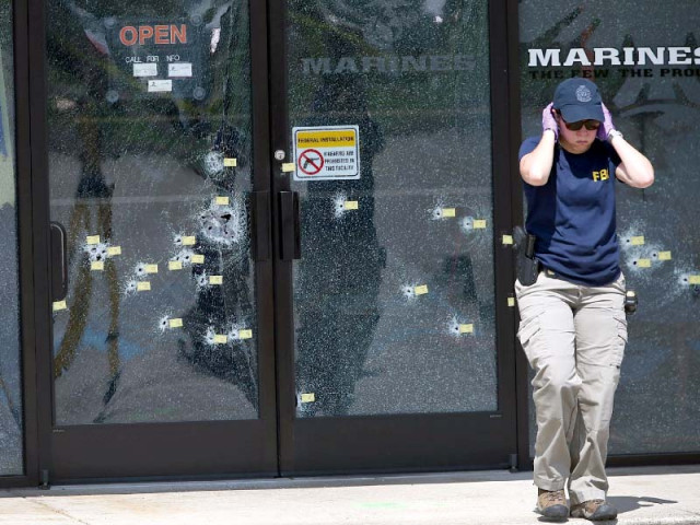 an fbi officer walks away from the bullet riddled doors at the armed forces career centre in chattanooga tennessee photo afp an fbi officer walks away from the bullet riddled doors at the armed forces career centre in chattanooga tennessee photo afp