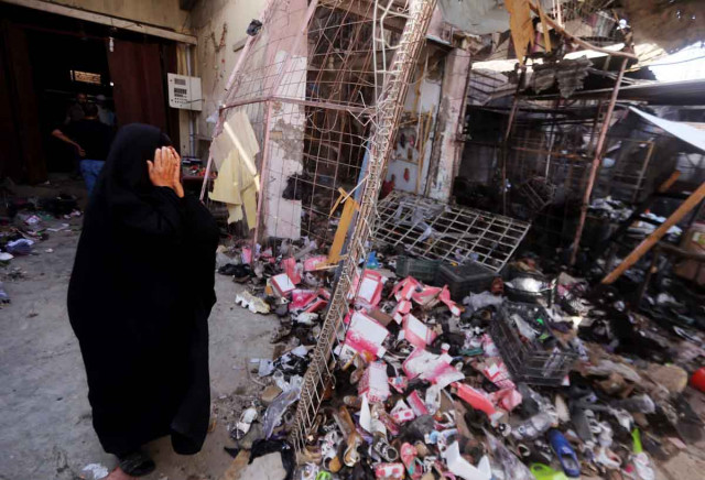 an iraqi woman reacts as she stands amid the debris in the aftermath of a massive suicide car bomb attack carried out by the islamic state group in the predominantly shia town of khan bani saad 20 km north of baghdad on july 18 2015 photo afp an iraqi woman reacts as she stands amid the debris in the aftermath of a massive suicide car bomb attack carried out by the islamic state group in the predominantly shia town of khan bani saad 20 km north of baghdad on july 18 2015 photo afp