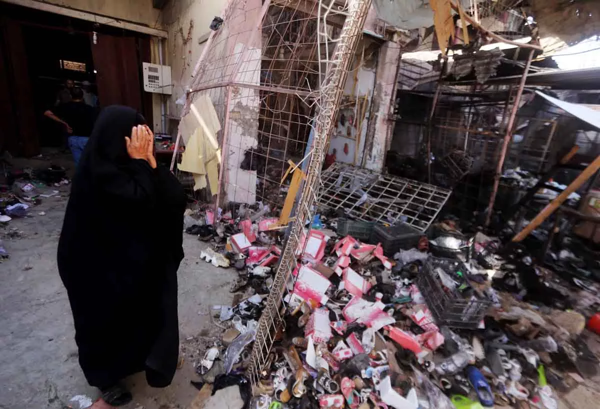 an iraqi woman reacts as she stands amid the debris in the aftermath of a massive suicide car bomb attack carried out by the islamic state group in the predominantly shia town of khan bani saad 20 km north of baghdad on july 18 2015 photo afp