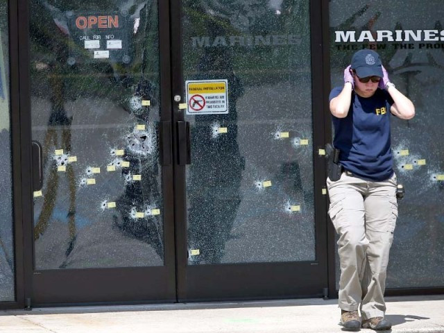 an fbi officer walks away from the bullet riddled doors at the armed forces career centre in chattanooga tennessee photo afp an fbi officer walks away from the bullet riddled doors at the armed forces career centre in chattanooga tennessee photo afp