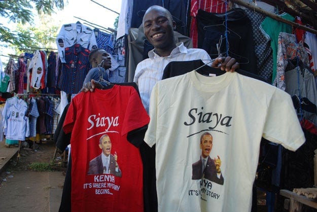 kenyan clothing vendor hosea owuor sets out a display of t shirts featuring an image of american president barrack obama at his stall in kisumu on july 8 2015 ahead of obama 039 s visit to kenya obama will be embarking upon his fourth visit to africa since becoming us president but his first to kenya since taking office in 2009 photo afp