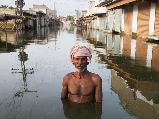 ahmed stands in the centre of the town of khairpur nathan shah which had been totally submerged by floodwaters photo getty