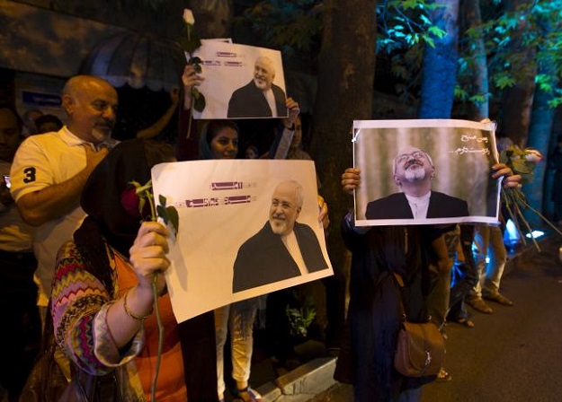 iranians hold pictures of iranian foreign minister mohammad javad zarif as they celebrate in the street following a nuclear deal with major powers in tehran july 14 2015 photo reuters