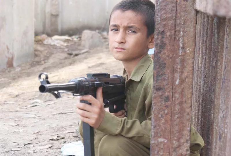a child poses with a toy kalashnikov psychologists fear that playing with such toys promotes an acceptability of violence and children who play with them are more susceptible to be drawn towards terrorism photo ppi a child poses with a toy kalashnikov psychologists fear that playing with such toys promotes an acceptability of violence and children who play with them are more susceptible to be drawn towards terrorism photo ppi
