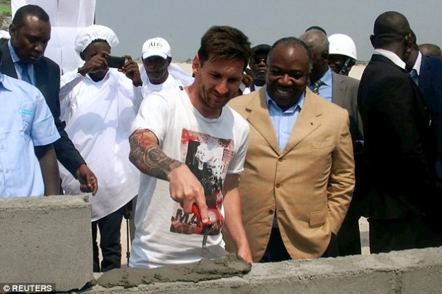messi helps lay a stone alongside president ali bongo photo reuters messi helps lay a stone alongside president ali bongo photo reuters