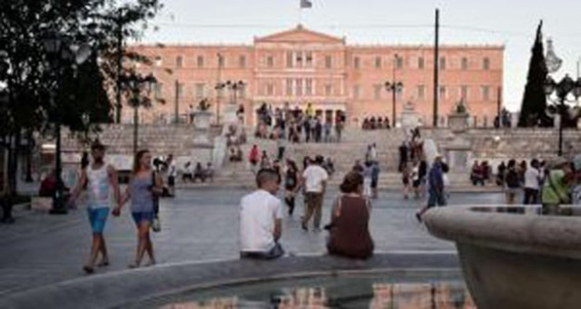 people sit outside the greek parliament in athens standard amp poor s rating raised greece s credit rating by two notches photo afp people sit outside the greek parliament in athens standard amp poor s rating raised greece s credit rating by two notches photo afp