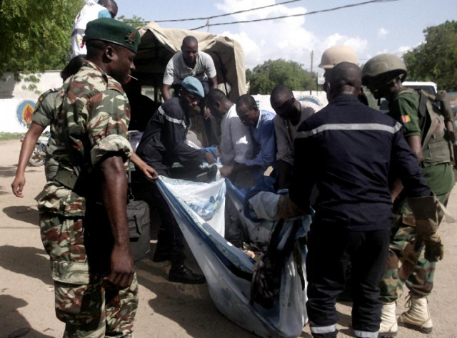 security forces transport with a blanket the remains of some of the eleven victims of a double blast in the northern cameroonian city of maroua on july 22 2015 photo afp security forces transport with a blanket the remains of some of the eleven victims of a double blast in the northern cameroonian city of maroua on july 22 2015 photo afp