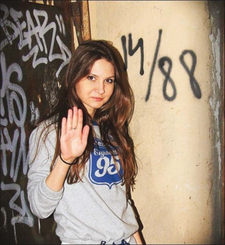 kuzkova extends her hand in a nazi salute as she stands in front of racist graffiti photo vkontakte kuzkova extends her hand in a nazi salute as she stands in front of racist graffiti photo vkontakte