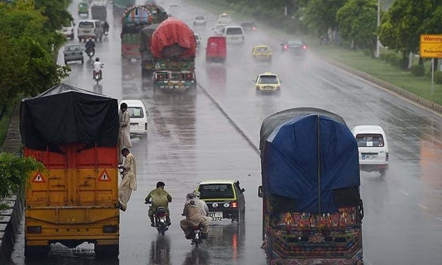 pakistani motorists drive along a motorway during monsoon rain in islamabad photo afp