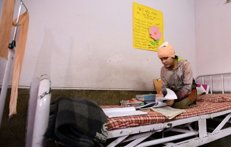 a nepalese acid attack survivor in her hospital room in kathmandu afp