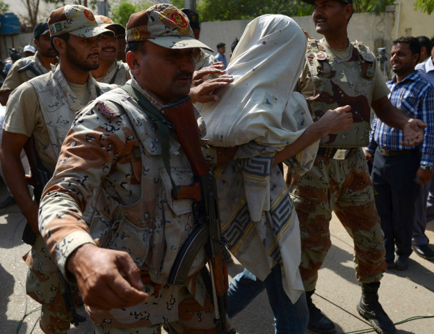 pakistani paramilitary soldiers escort suspect moazzam ali khan photo afp pakistani paramilitary soldiers escort suspect moazzam ali khan photo afp