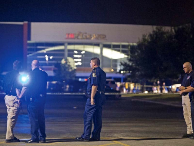 officials stand outside the theatre where a man opened fire on film goers photo reuters officials stand outside the theatre where a man opened fire on film goers photo reuters