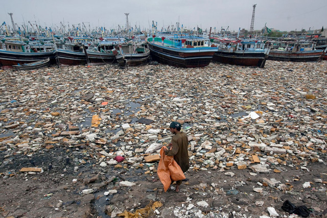 a boy looks for recyclable items in the polluted waters of karachi harbour pakistan photo reuters a boy looks for recyclable items in the polluted waters of karachi harbour pakistan photo reuters