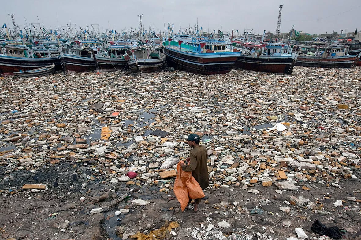 a boy looks for recyclable items in the polluted waters of karachi harbour pakistan photo reuters a boy looks for recyclable items in the polluted waters of karachi harbour pakistan photo reuters