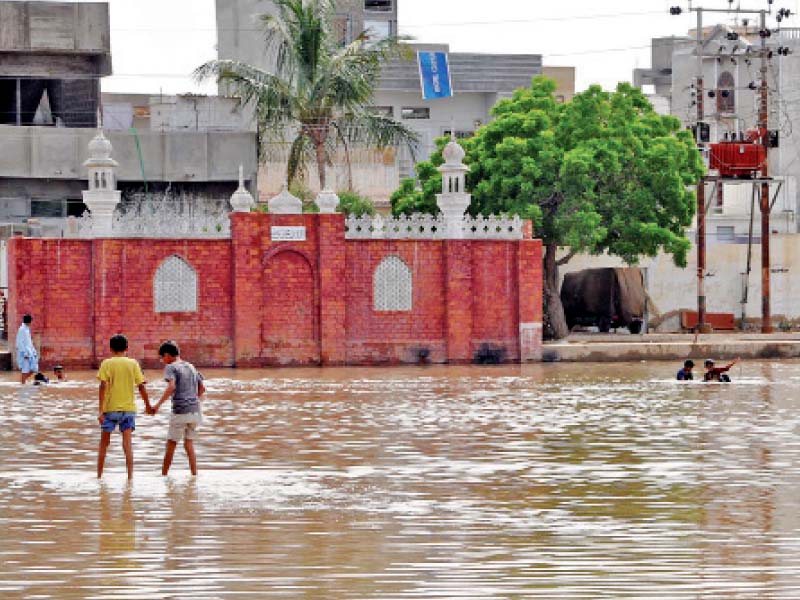 children can be seen playing in stagnant rainwater at eidgah ground after heavy rainfall on thursday the city is expecting the next wave of monsoon rains from monday photo ppi