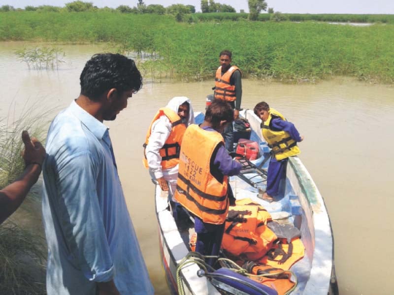 a farmer prepares to board a rescue 1122 boat in dera ghazi khan photo tariq ismaeel express