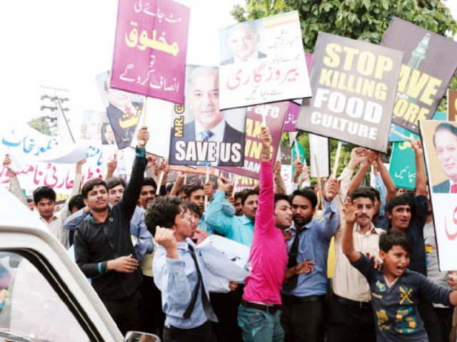 protesters holding up placards and shouting slogans photo shafiq malik express protesters holding up placards and shouting slogans photo shafiq malik express