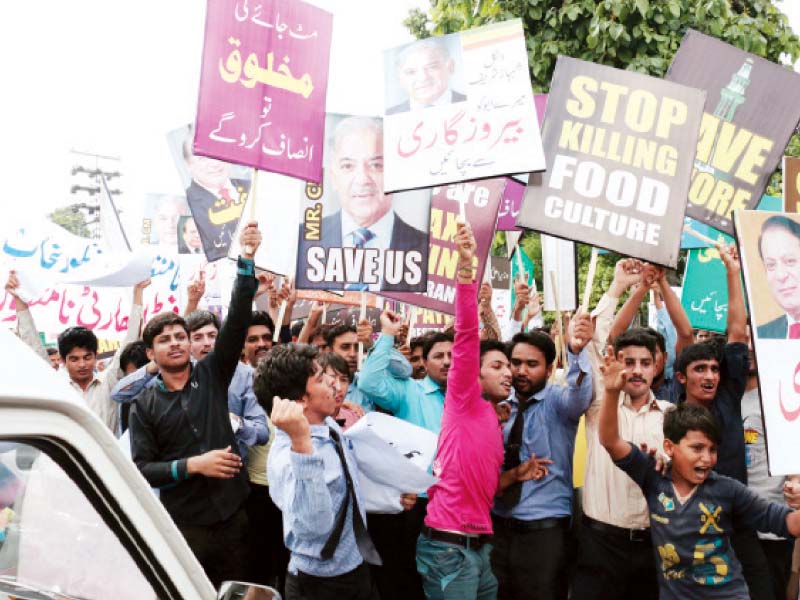 protesters holding up placards and shouting slogans photo shafiq malik express