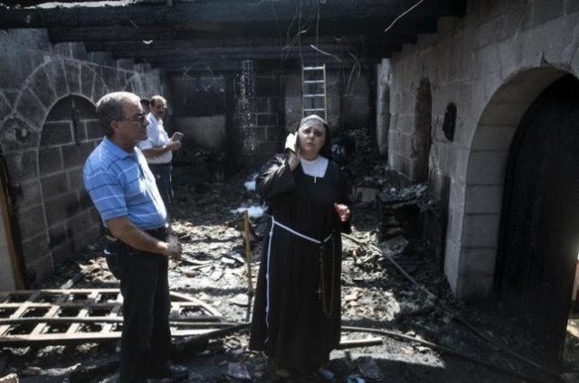 a nun stands at the scene of a fire in the church of loaves and fishes on the shores of the sea of galilee in northern israel june 18 2015 photo reuters a nun stands at the scene of a fire in the church of loaves and fishes on the shores of the sea of galilee in northern israel june 18 2015 photo reuters