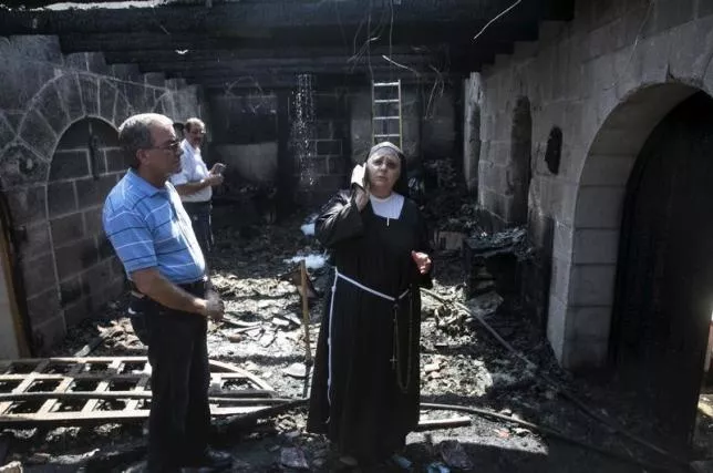 a nun stands at the scene of a fire in the church of loaves and fishes on the shores of the sea of galilee in northern israel june 18 2015 photo reuters