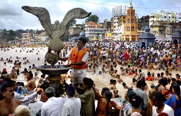 an indian lifesaver wearing a safety jacket l stands on the banks of the godavari river at nashik during the kumbh mela india is set to become the world 039 s most populous country by 2022 photo afp an indian lifesaver wearing a safety jacket l stands on the banks of the godavari river at nashik during the kumbh mela india is set to become the world 039 s most populous country by 2022 photo afp