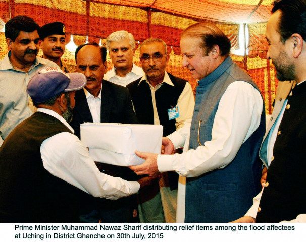 prime minister nawaz sharif distributing relief items amongst flood affectees in uching in district ghanche in gilgit baltistan photo pid