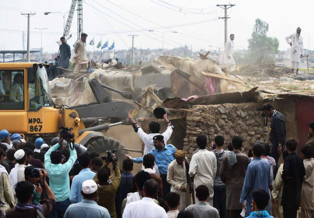 capital development authority cda workers demolish a poverty stricken neighbourhood where afghan refugees and pakistani tribal people live in islamabad on july 30 2015 photo afp capital development authority cda workers demolish a poverty stricken neighbourhood where afghan refugees and pakistani tribal people live in islamabad on july 30 2015 photo afp