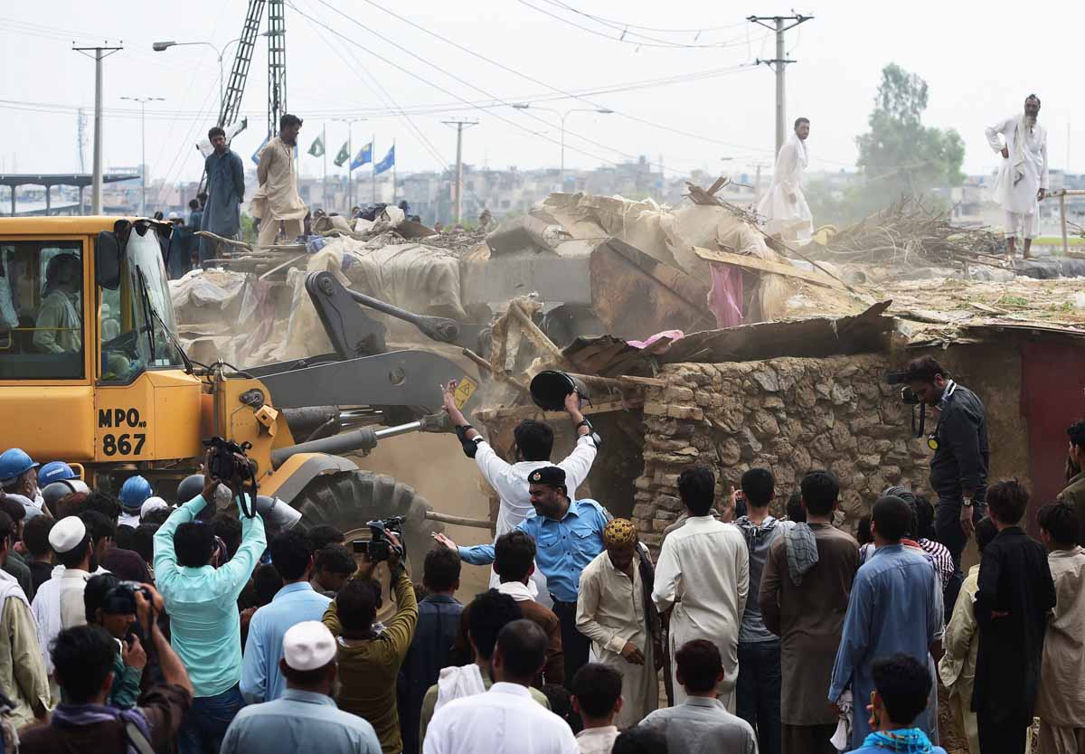 capital development authority cda workers demolish a poverty stricken neighbourhood where afghan refugees and pakistani tribal people live in islamabad on july 30 2015 photo afp