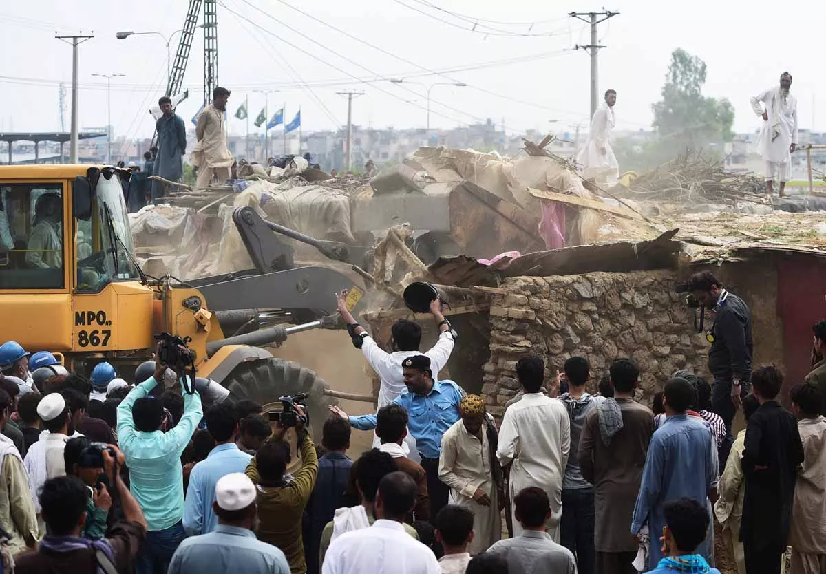 capital development authority cda workers demolish a poverty stricken neighbourhood where afghan refugees and pakistani tribal people live in islamabad on july 30 2015 photo afp capital development authority cda workers demolish a poverty stricken neighbourhood where afghan refugees and pakistani tribal people live in islamabad on july 30 2015 photo afp