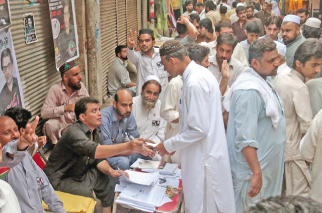 voters gather around a polling agent outside karimpur polling station in the city photos muhammad iqbal express amp syed noman shah voters gather around a polling agent outside karimpur polling station in the city photos muhammad iqbal express amp syed noman shah