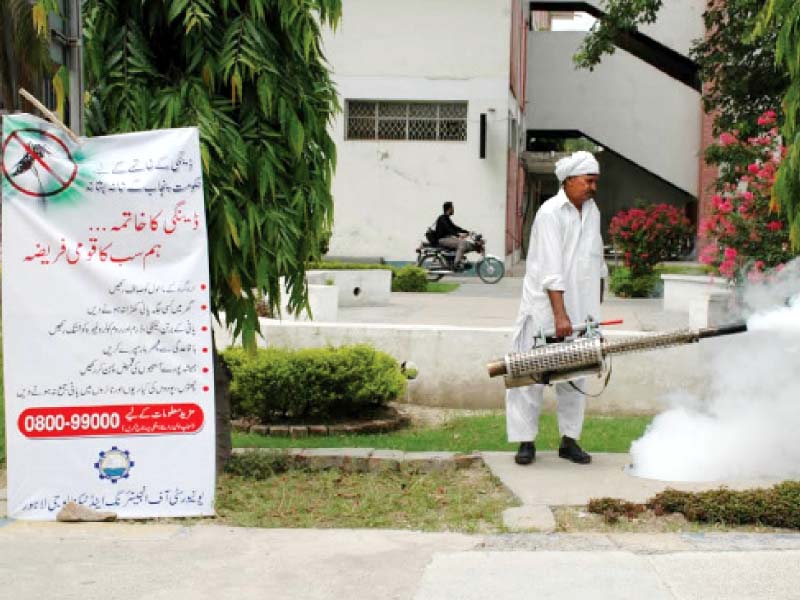a worker at uet spraying dengue mosquito pesticide at the uet campus in connection with the anti dengue day photo abid nawaz express