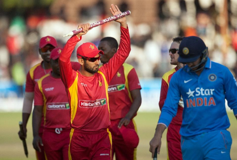 zimbabwe stand in captain raza butt l salutes the crowd after securing a victory during the second and final game in a series of two twenty20 international matches between zimbabwe and india photo afp