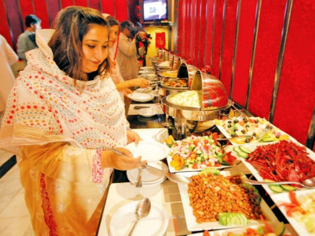 a visitor choosing from the different dishes on offer photo courtesy pearl continental peshawar a visitor choosing from the different dishes on offer photo courtesy pearl continental peshawar