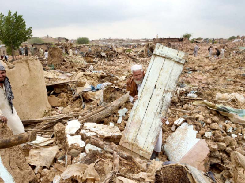 an elderly man shifts a house door from the debris of demolished houses local authorities are expecting to complete operation by sunday photo afp