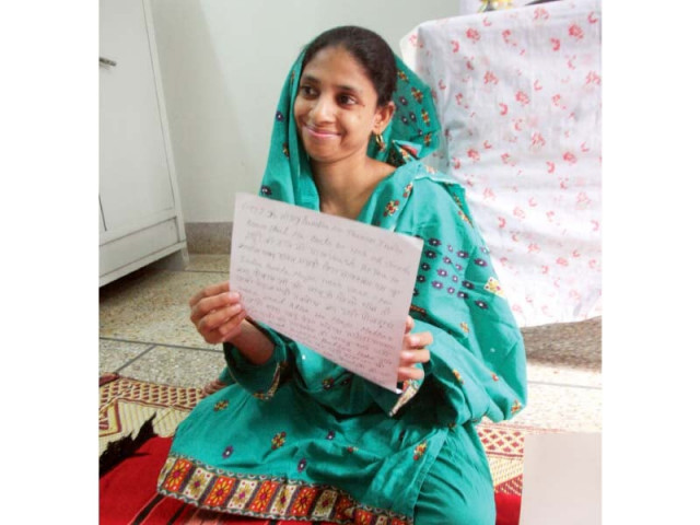 geeta smiles as she shows one of her writings in hindi photo athar khan express geeta smiles as she shows one of her writings in hindi photo athar khan express