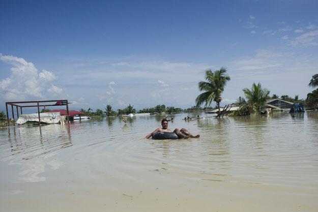 a flood affected resident uses a make shift raft to travel through floodwaters in kalay upper myanmar 039 s sagaing region on august 3 2015 photo afp