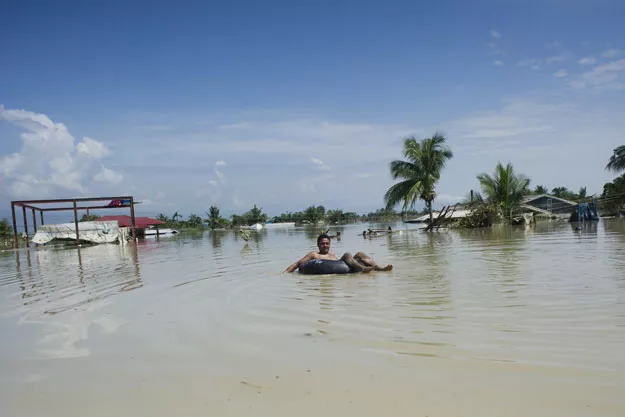 a flood affected resident uses a make shift raft to travel through floodwaters in kalay upper myanmar 039 s sagaing region on august 3 2015 photo afp a flood affected resident uses a make shift raft to travel through floodwaters in kalay upper myanmar 039 s sagaing region on august 3 2015 photo afp