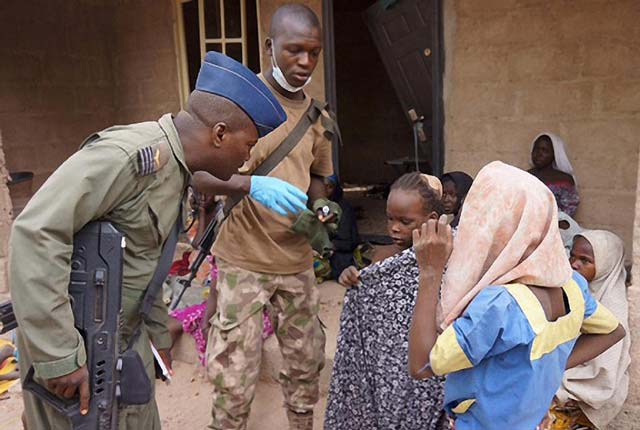 nigerian soldiers talk to girls rescued during an operation against boko haram militants in the sambisa forest borno state in april 2015 photo afp