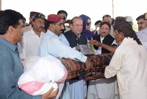 prime minister nawaz sharif distributes relief goods among flood victims of ghotki on august 4 2015 photo pid