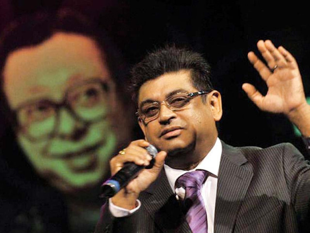 amit kumar poses in front of a portrait of rd burman photo file amit kumar poses in front of a portrait of rd burman photo file