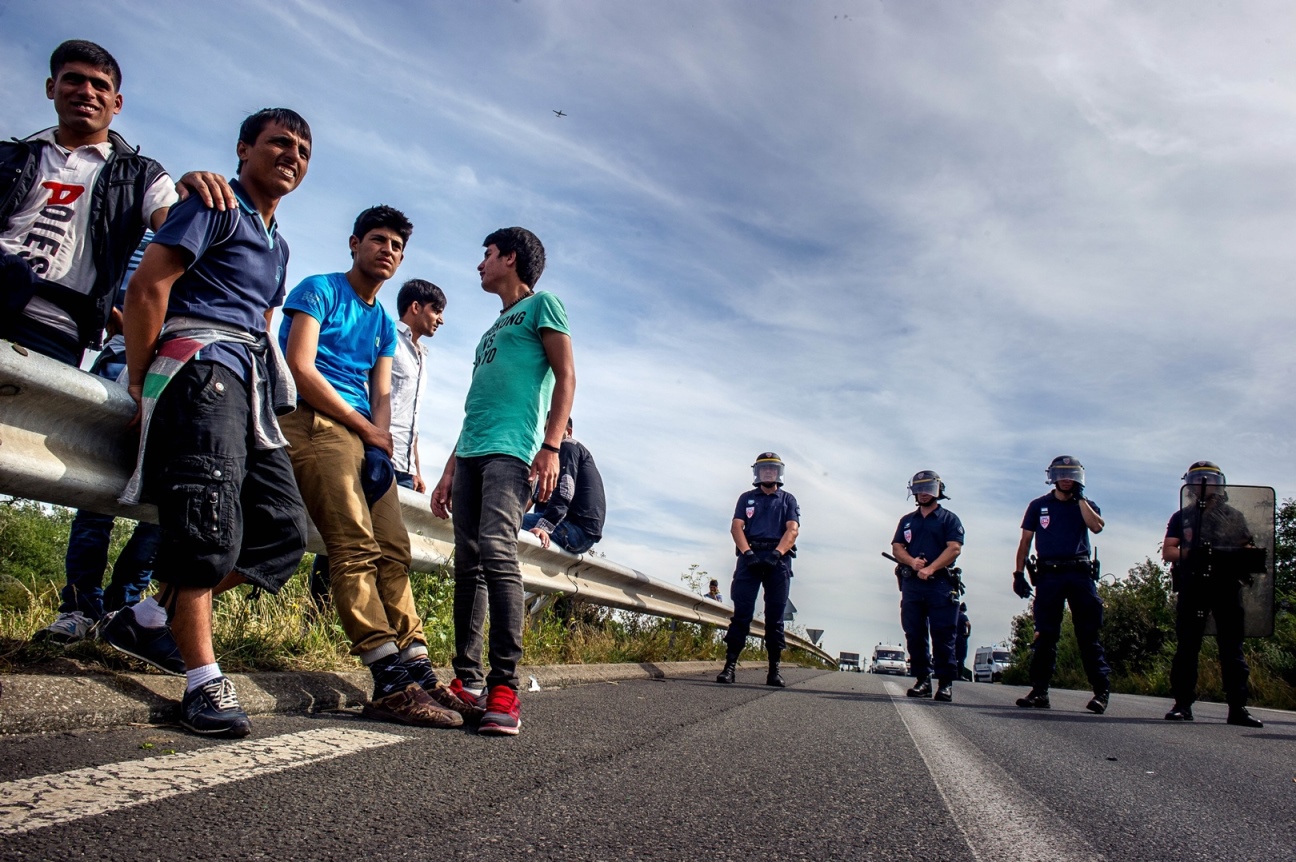 french riot police stand on a road to prevent migrants from reaching the road leading to the ferry port in calais northern france on august 5 2015 photoi afp