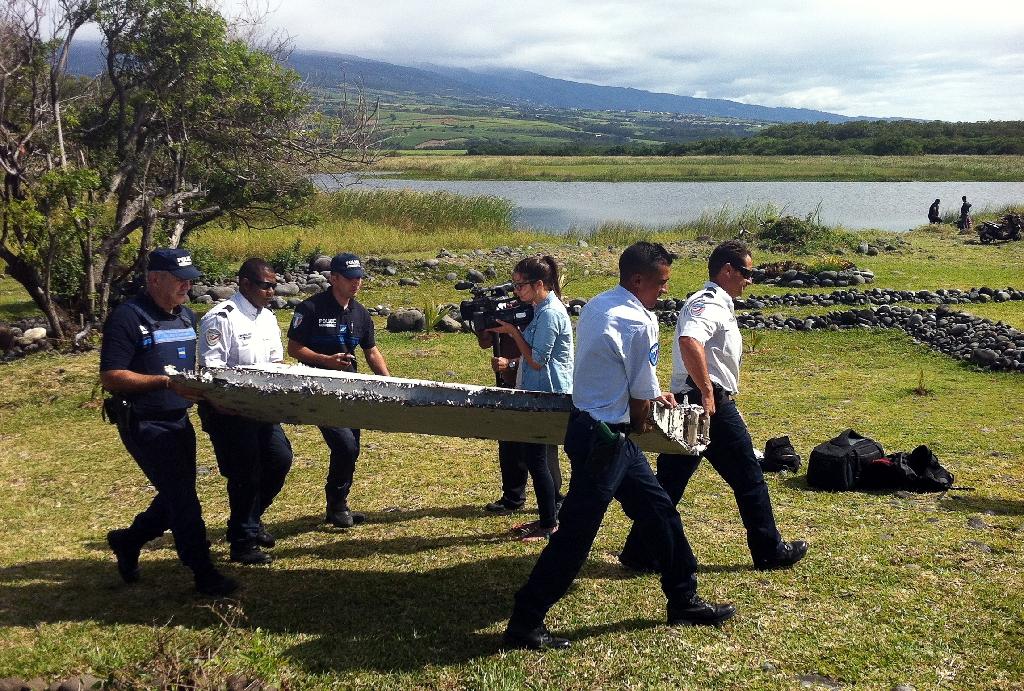 officials move a part of the debris that washed up on reunion island photo afp