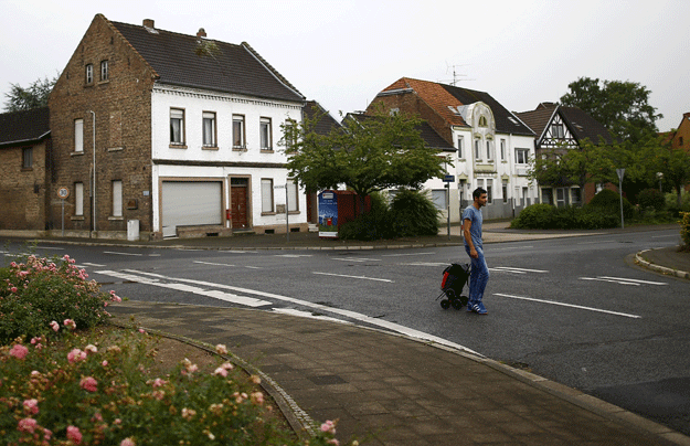 alban a 27 year old refugee from albania walks through the empty streets of the village of kerpen manheim on the way towards the bus station in manheim germany august 4 2015 photo reuters