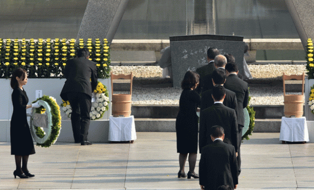 japanese prime minister shinzo abe 2nd l offers a wreath of flowers at the memorial cenotaph for victims of a 1945 atomic bombing during a memorial ceremony to mark the 70th anniversary at the hiroshima peace memorial park in western japan on august 6 2015 photo afp japanese prime minister shinzo abe 2nd l offers a wreath of flowers at the memorial cenotaph for victims of a 1945 atomic bombing during a memorial ceremony to mark the 70th anniversary at the hiroshima peace memorial park in western japan on august 6 2015 photo afp