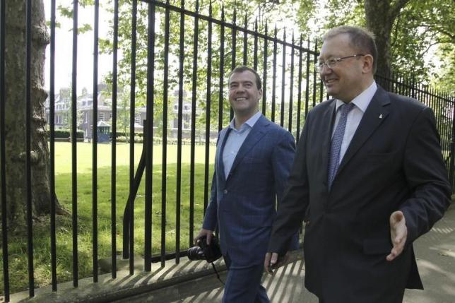 russia 039 s prime minister dmitry medvedev l accompanied by russia 039 s ambassador to britain alexander yakovenko walks before attending an interview in london july 28 2012 photo reuters