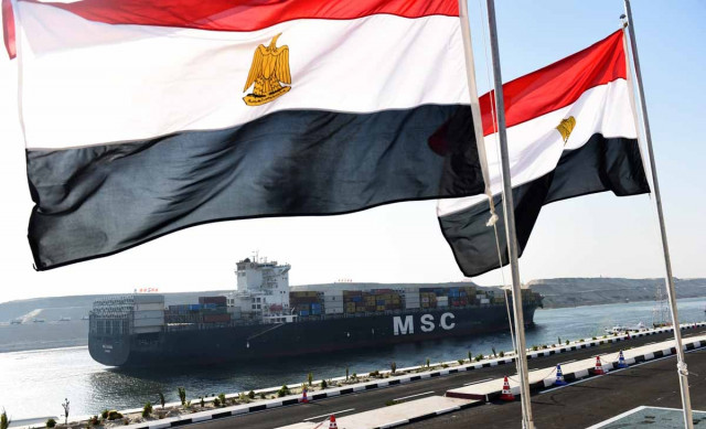 a cargo ship crosses a new waterway at the suez canal during its opening ceremony on august 6 2015 in the port city of ismailiya photo afp a cargo ship crosses a new waterway at the suez canal during its opening ceremony on august 6 2015 in the port city of ismailiya photo afp