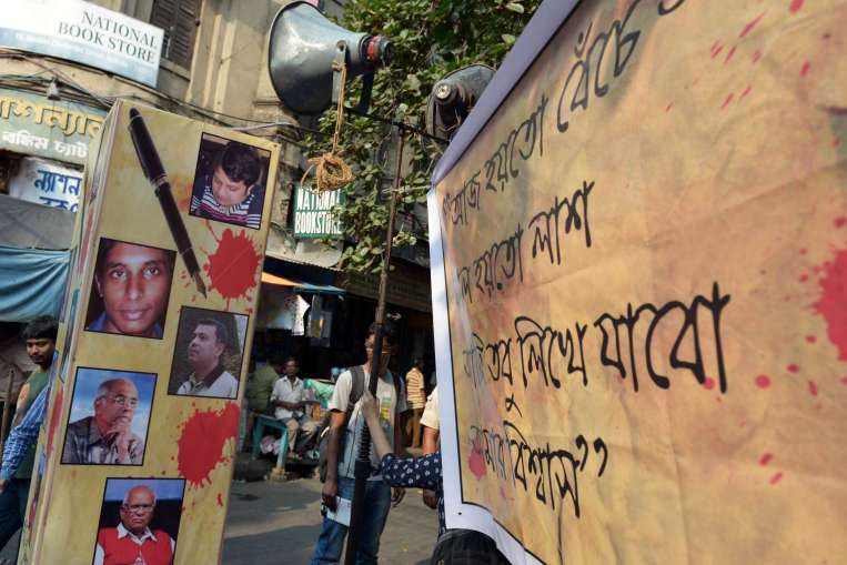 a poster with pictures of slain bangladeshi bloggers during a protest meeting organised to pay homage on may 16 2015 photo afp