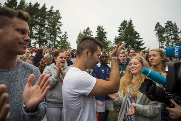 mani hussaini c the president of norwegian labour party youth division auf greets activists accompanied by former leader and terror attack survivor eskil pedersen l at the utoya island some 40 km west of oslo on august 7 2015 after opening their first summer camp session since the 2011 bloodbath photo afp