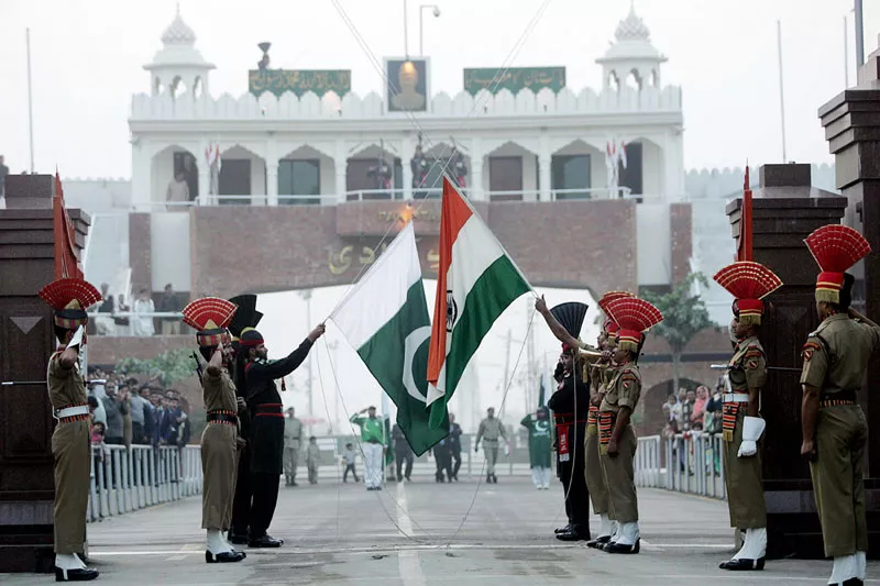pakistan rangers r and border security force personnel take part in the daily flag lowering ceremony at their joint border post of wagah near lahore photo afp