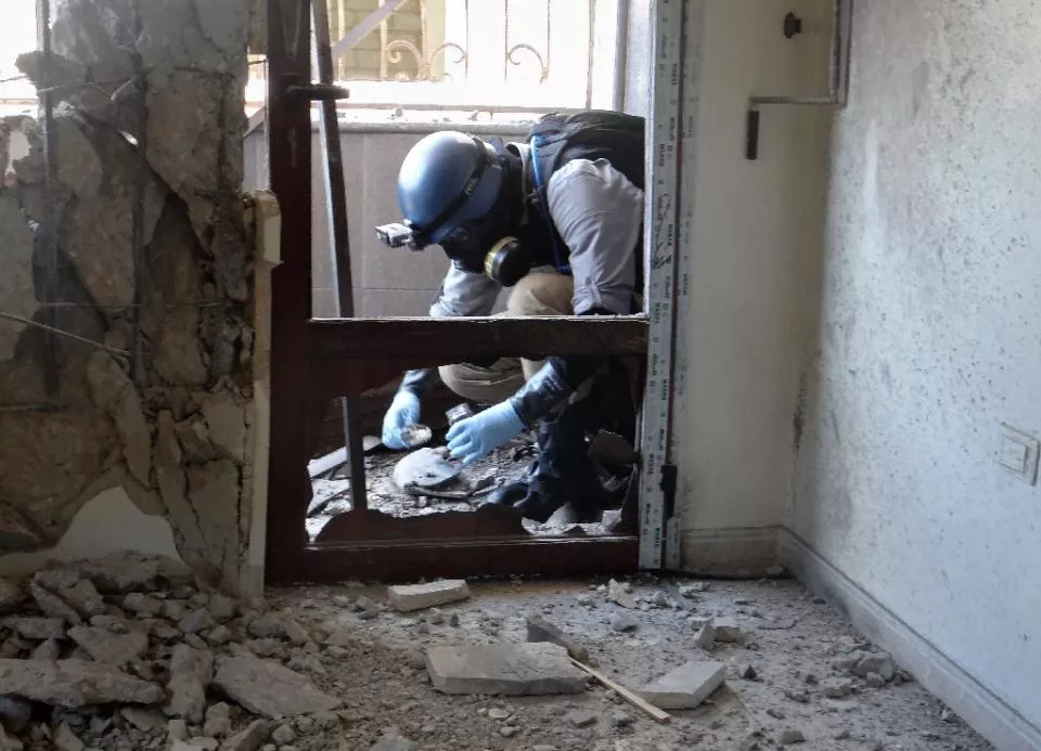 a united nations weapons expert collects samples during an investigation into a 2013 suspected chemical weapons strike near damascus photo afp a united nations weapons expert collects samples during an investigation into a 2013 suspected chemical weapons strike near damascus photo afp